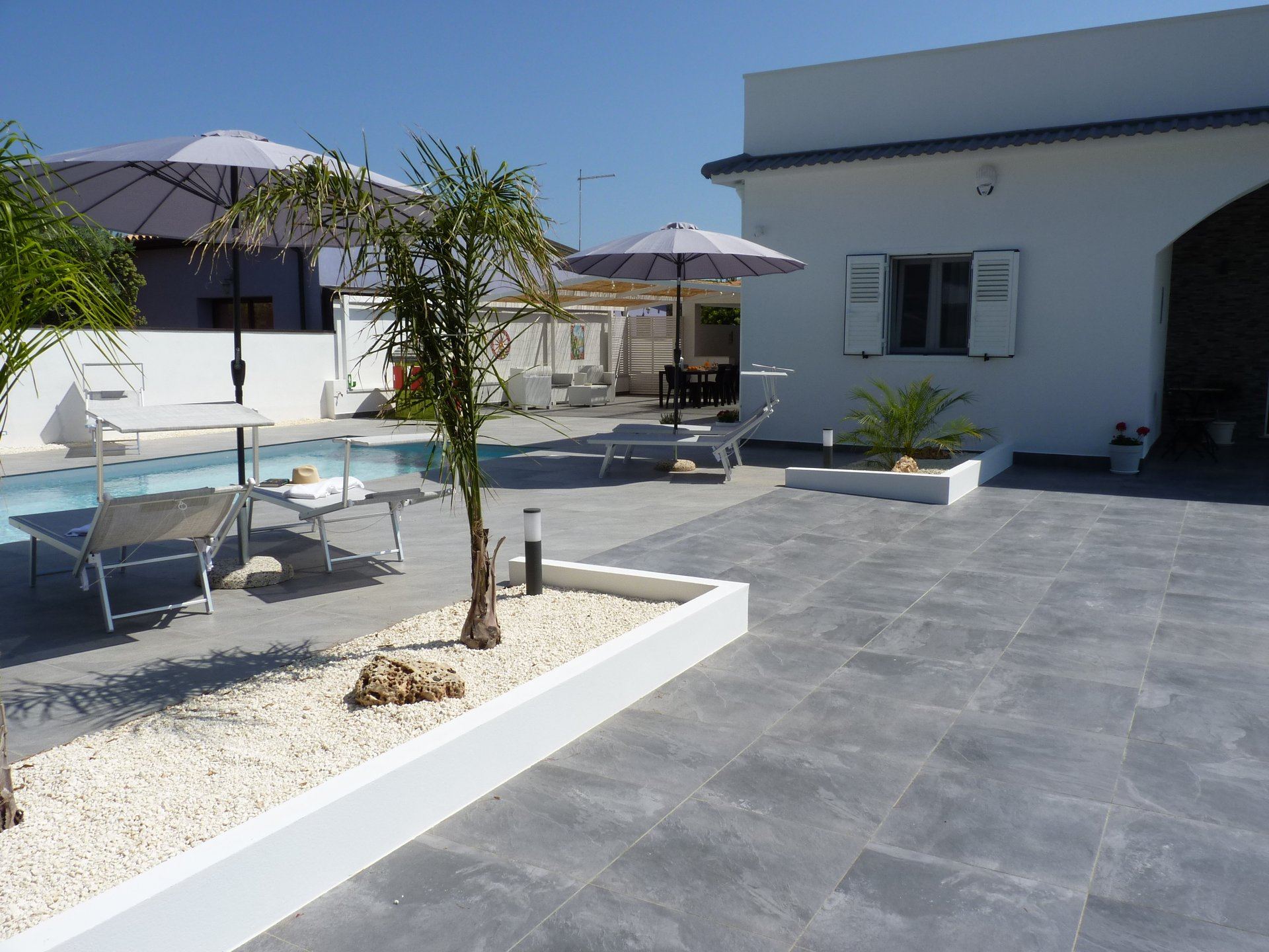 Welcoming villa entrance with traditional Sicilian stone pathway