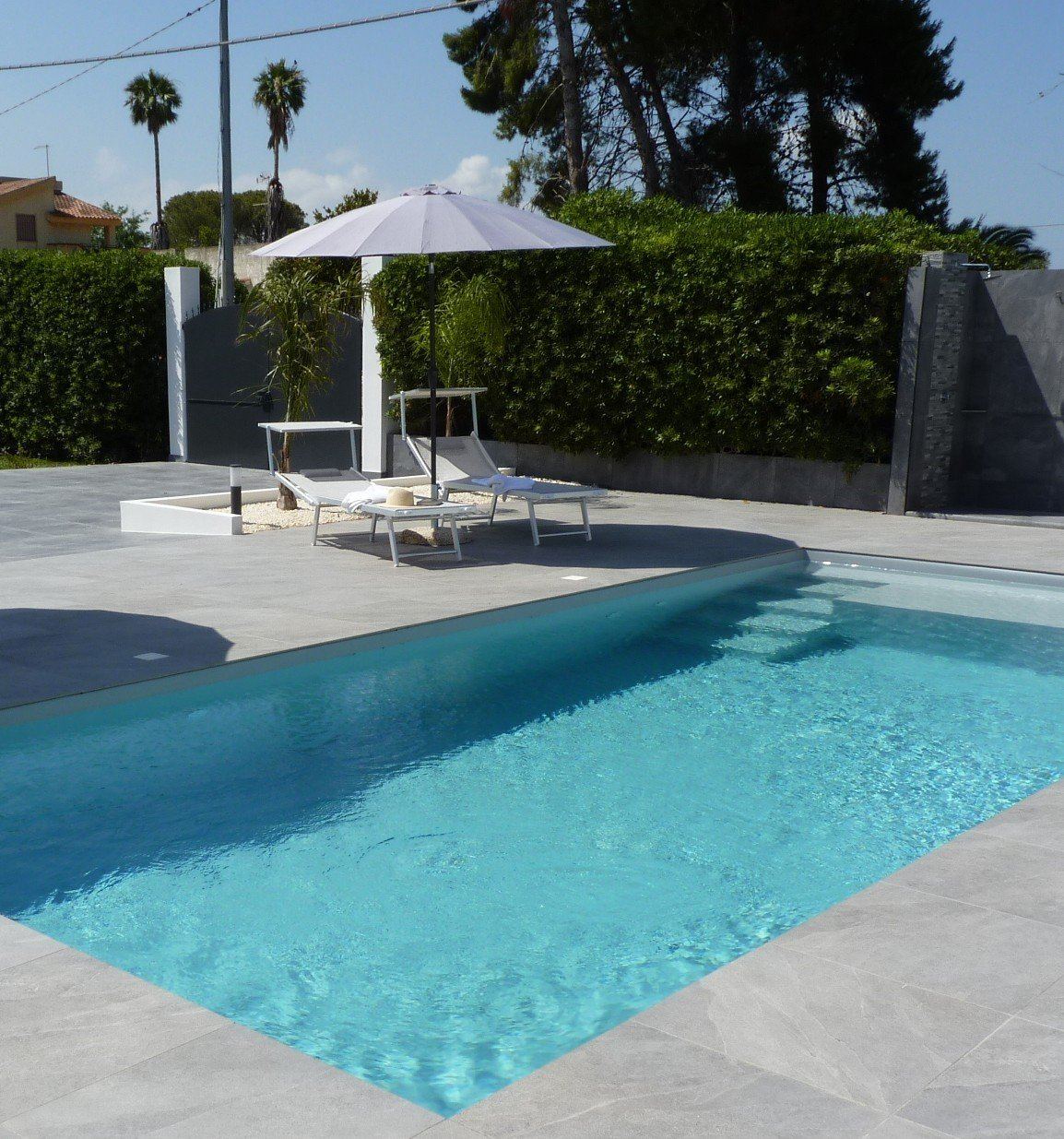 Private swimming pool surrounded by Mediterranean palms